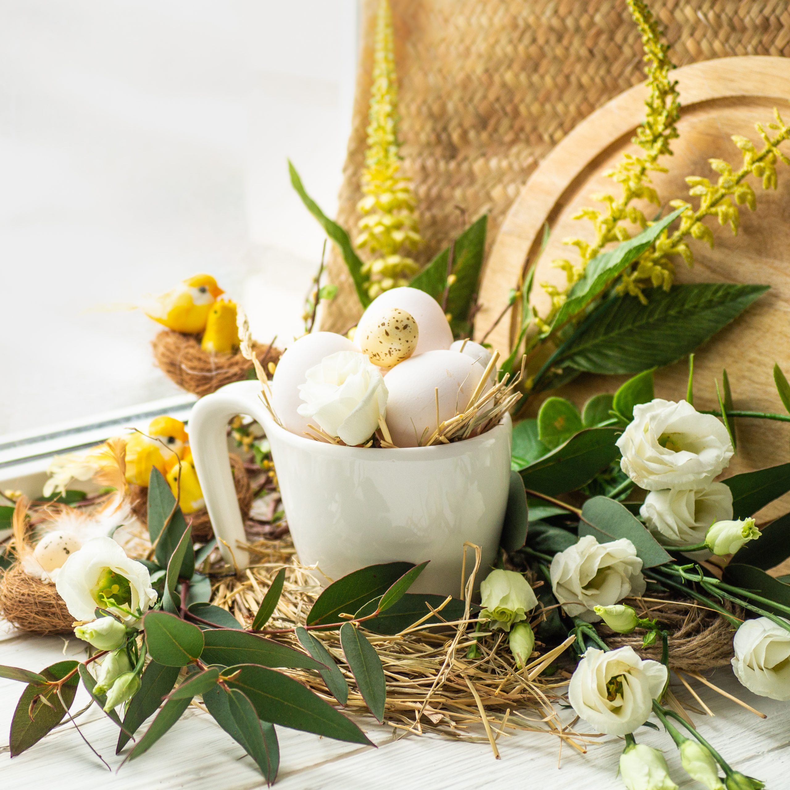 Happy Easter background. Easter egg in a nest with floral decoration near the window. Quail eggs. Happy Easter concept