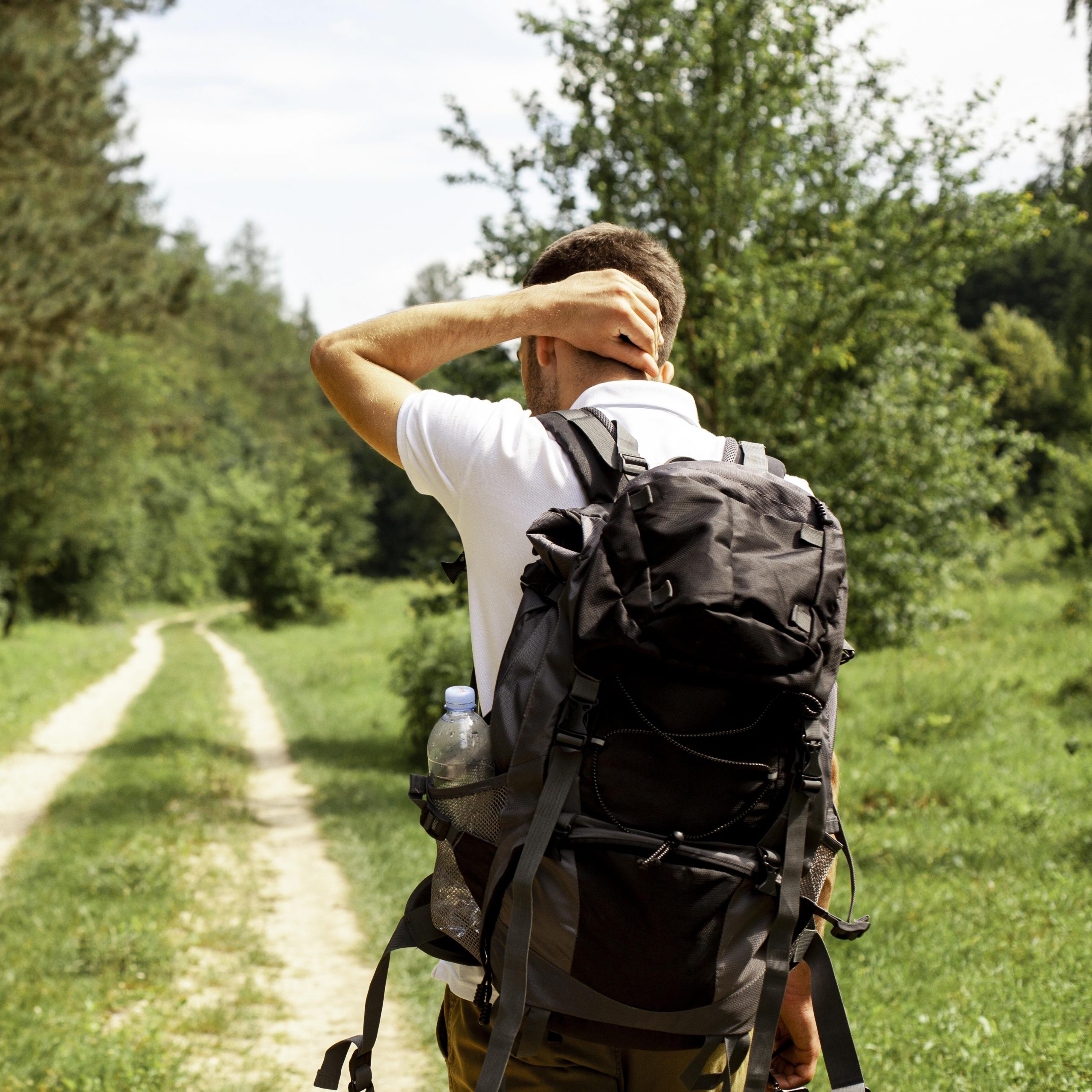 man-with-backpack-forest-road