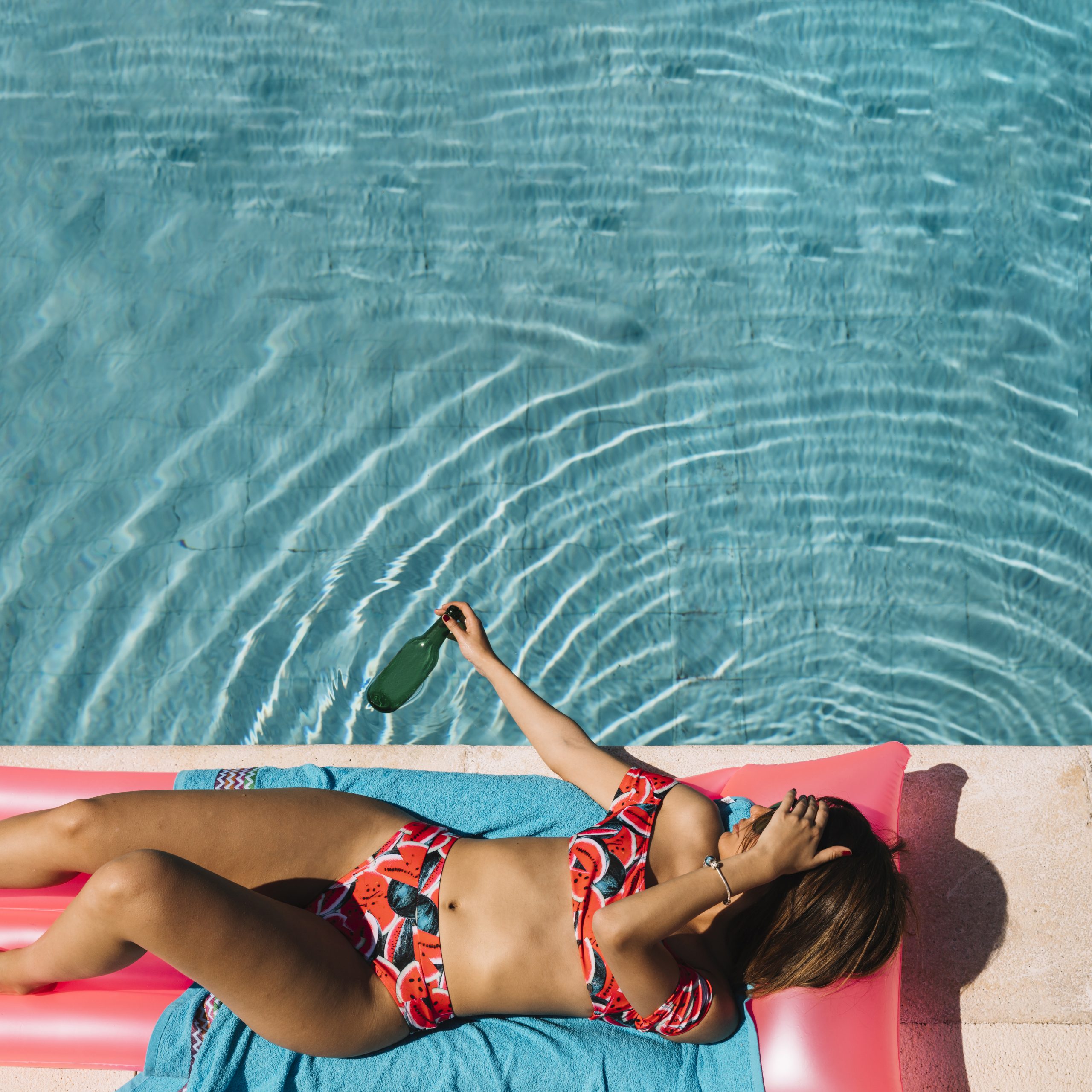 top-view-woman-relaxing-pool
